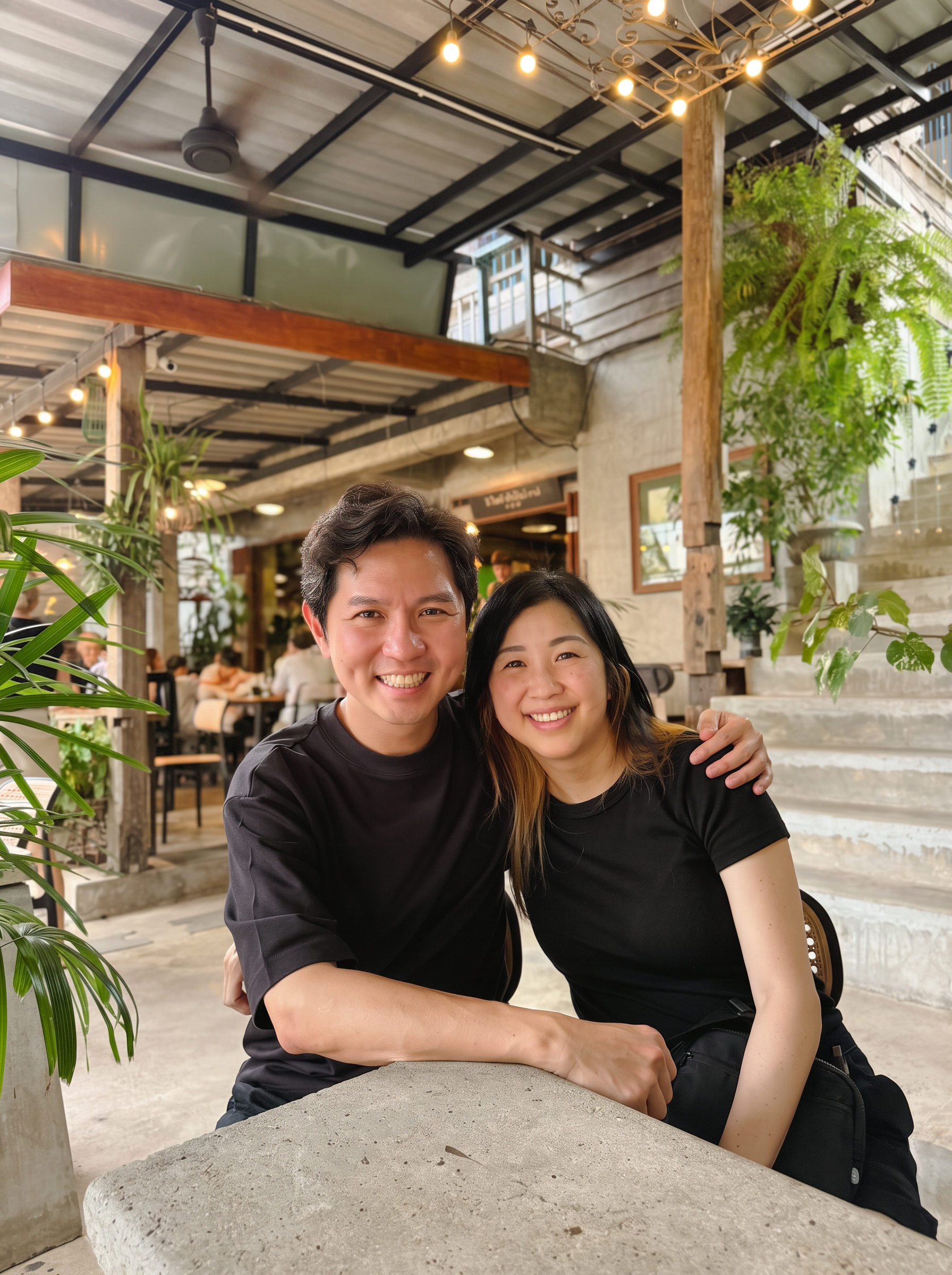Daniel Chua and his wife, seated together and smiling